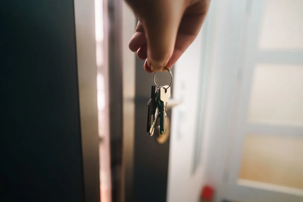 Keys being used at a modern home entry door